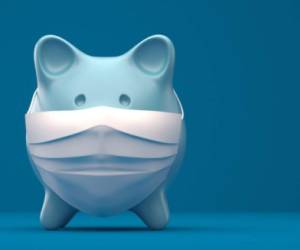 Piggy Bank Wearing A Surgical Mask over blue background.