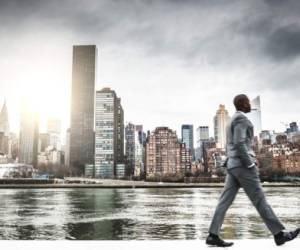 Successful business man looking away against the skyline