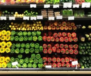 A colorful display of fresh vegetables in a grocery market store.