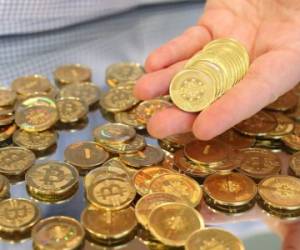 SALT LAKE CITY, UT - APRIL 26: Software engineer Mike Caldwell holds physical Bitcoins he minted in his shop on April 26, 2013 in Sandy, Utah. Bitcoin is an experimental digital currency used over the Internet that is gaining in popularity worldwide. (Photo by George Frey/Getty Images)