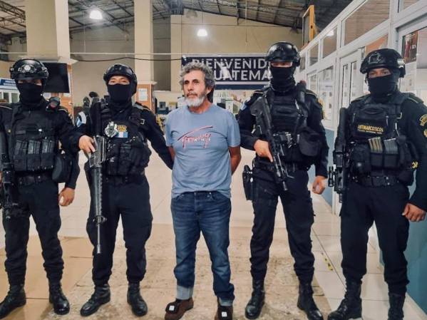 <i>Fotografía cedida por el Ministerio de Gobernación de Guatemala donde se ve al narcotraficante, Baldomero Samayoa, alias Chicharra (c) custodiado por miembros de la Policía Antinarcóticos de Guatemala este miércoles, en Ciudad de Guatemala (Guatemala). Samayoa es parte de la lista de los 100 más buscados por Estados Unidos y tiene una orden de extradición pendiente por lavado de dinero, así como trasiego de cocaína, heroína y otros ilícitos. EFE/ Ministerio de Gobernación de Guatemala </i>