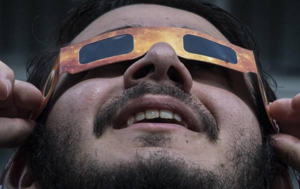 <i>Un hombre observa el eclipse anular de sol en el planetario de la Universidad de Costa Rica (UCR) en San José, el 14 de octubre de 2023. Los observadores del cielo de toda América volvieron sus rostros hacia arriba el sábado para presenciar un raro evento celeste: un eclipse solar anular. FOTO Ezequiel BECERRA/AFP</i>