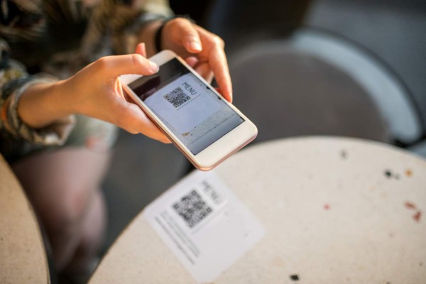 woman scanning qr code for online menu