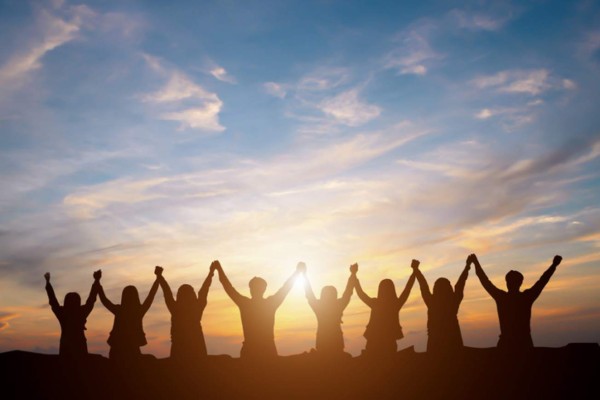 Silhouette of happy business team making high hands in sunset sky background for business teamwork concept