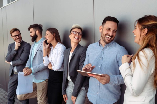 Business people discussing over documents in modern office lobby.