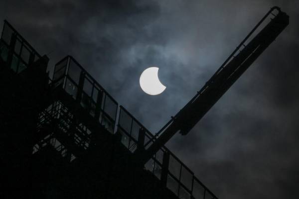 <i>A general view showing a partial solar eclipse in Jakarta on April 20, 2023. (Photo by BAY ISMOYO / AFP)</i>