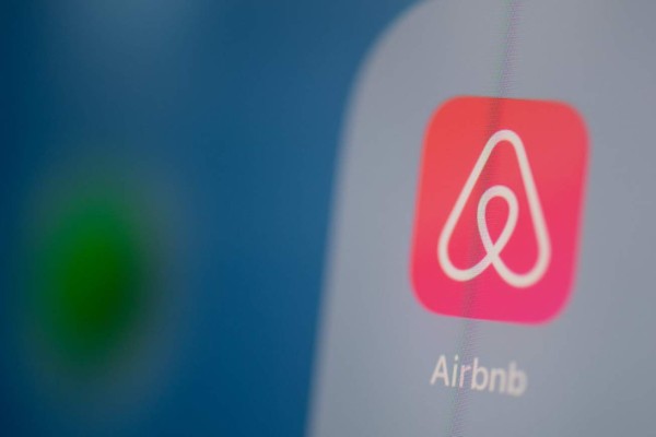 This illustration picture taken on July 24, 2019 in Paris shows the logo of the US online booking homes application Airbnb on the screen of a tablet. (Photo by Martin BUREAU / AFP)