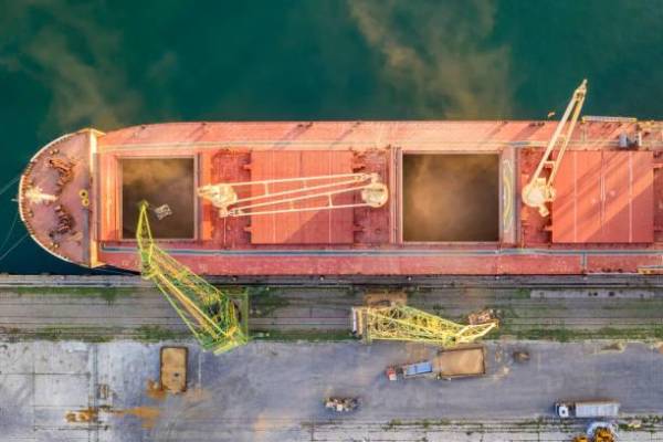 Top view from drone of a large ship loading grain for export. Water transport