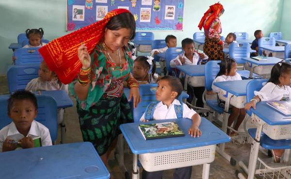<i>Niños de distintas comunidades indígenas asisten a una clase en el Centro Educativo Bilingüe Icanti este lunes, en Icanti (Panamá). Degidde nuegambi. Así se dice hola, ¿cómo están? en dulegayá, el idioma de la etnia guna, y es la pregunta con la que un docente recibe a un grupo de infantes vestidos con las prendas tradicionales indígenas en el primer día de clases en el Centro Educativo Bilingüe Icanti, situado en esta apartada comunidad de la comarca Madugandí de Panamá. EFE/ Carlos Lemos</i>