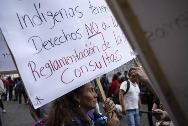 <i>Miembros indígenas de organizaciones sociales participan en una vigilia para apoyar la democracia frente al Palacio Nacional de la Cultura, antigua sede del Gobierno en la Ciudad de Guatemala, el 13 de enero de 2024. FOTO MARTIN BERNETTI / AFP</i>