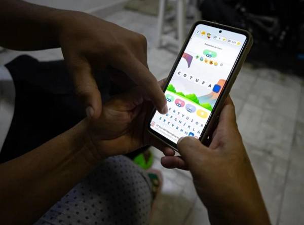 <i>Una persona usando la aplicación ‘Venezolario’, en Caracas (Venezuela). EFE/ Ronald Peña R.</i>