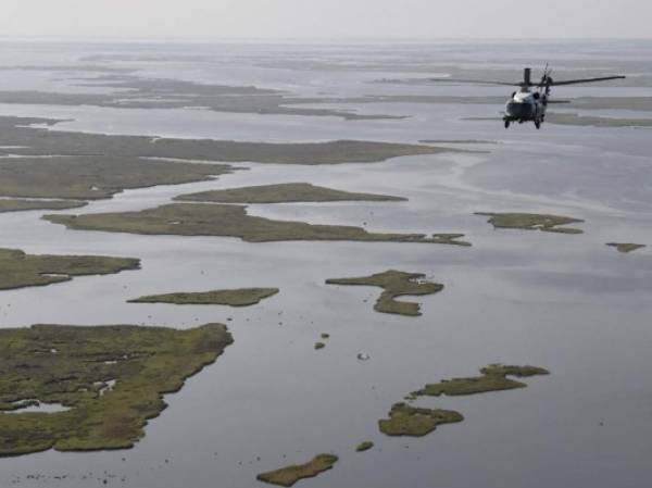 US President Joe Biden, aboard the Marine One helicopter, inspects the damage from Hurricane Ida on an aerial tour of communities in Laffite, Grand Isle, Port Fourchon and Lafourche Parish, Louisiana, September 3, 2021. - President Joe Biden, who has made threats from climate change a priority, arrived in New Orleans to tour damage from Hurricane Ida, which pounded the Gulf Coast before bringing havoc to New York. (Photo by JONATHAN ERNST / POOL / AFP) (Photo by JONATHAN ERNST/POOL/AFP via Getty Images)