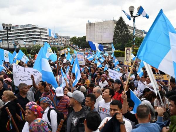 <i>ARCHIVO. La gente participa en una protesta para exigir la renuncia de la fiscal general Consuelo Porras y del fiscal Rafael Curruchiche, acusados de generar una crisis electoral para afectar al presidente electo de Guatemala, Bernardo Arévalo, y al partido Semilla, en la Ciudad de Guatemala el 18 de septiembre de 2023.Johan ORDÓNEZ / AFP</i>