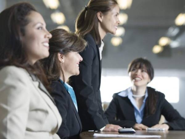 Four businesswomen in a meeting in the board room