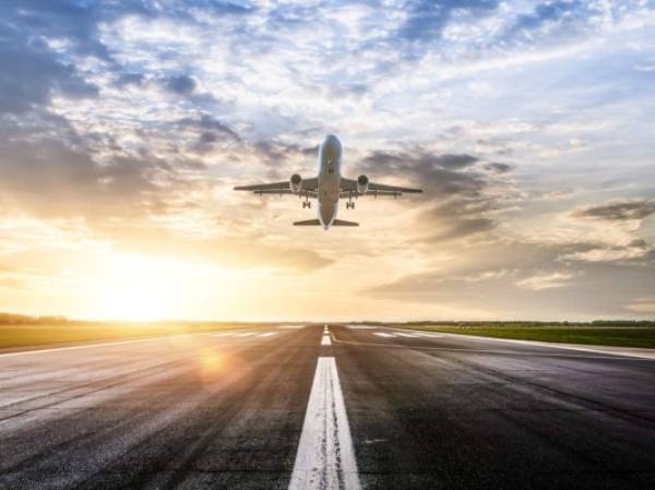 Passenger airplane taking of at sunrise