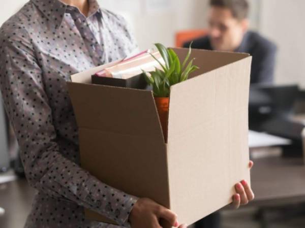 Close up view of new female employee intern holding cardboard box with belongings start finish job in company office, busnesswoman newcomer worker get hired fired on first last day at work concept