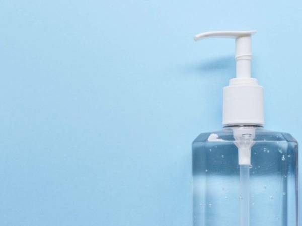 Bottle of a hand sanitizer against blue background