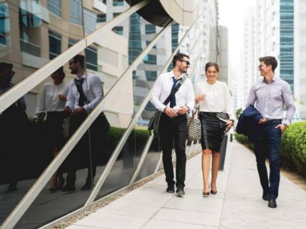 Group of business people walking talking.