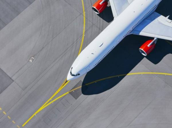 Aerial view of airport. Airplane taxiing to runway before take off.