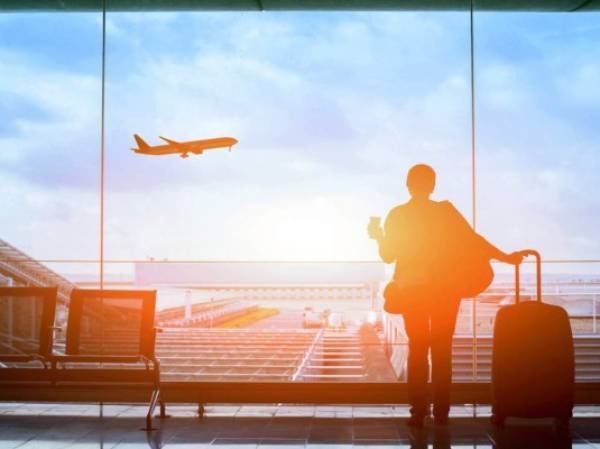 happy traveler waiting for the flight in airport, departure terminal, immigration concept