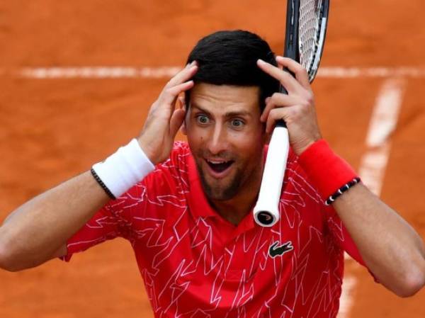 Serbia's Novak Djokovic reacts as he takes part in tennis match during a charity exhibition hosted by him, in Belgrade on June 12, 2020. - Novak Djokovic has also tested positive for coronavirus on June 23, 2020 along with Grigor Dimitrov, Borna Coric and Viktor Troicki, after taking part in an exhibition tennis tournament in the Balkans featuring world number one Novak Djokovic, raising questions over the sport's planned return in August. (Photo by Andrej ISAKOVIC / AFP)