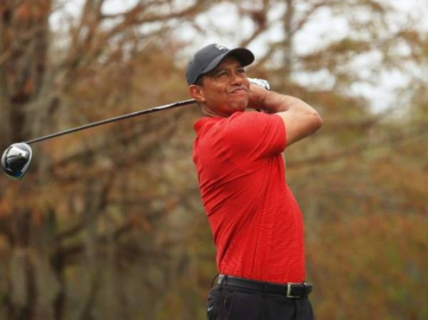 ORLANDO, FLORIDA - DECEMBER 20: Tiger Woods of the United States plays his shot from the ninth tee during the final round of the PNC Championship at the Ritz-Carlton Golf Club Orlando on December 20, 2020 in Orlando, Florida. Mike Ehrmann/Getty Images/AFP (Photo by Mike Ehrmann / GETTY IMAGES NORTH AMERICA / Getty Images via AFP)