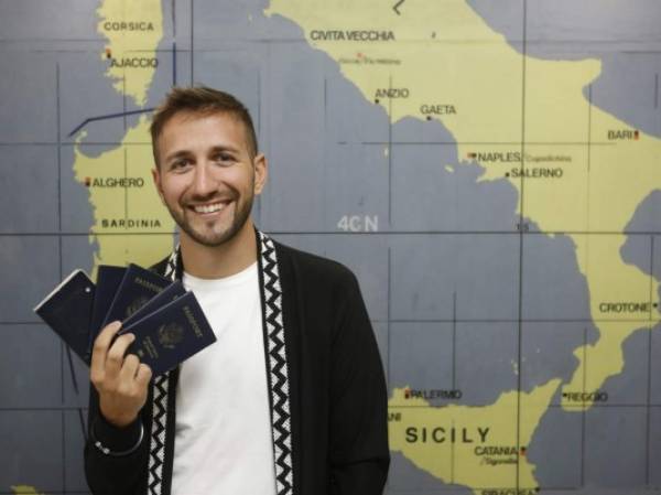 Dan Lavallo poses with his passports on Friday, Nov. 17, 2017 at Luqa&#39;s international airport, Malta. (Riccardo De Luca/AP Images for Marriott International)