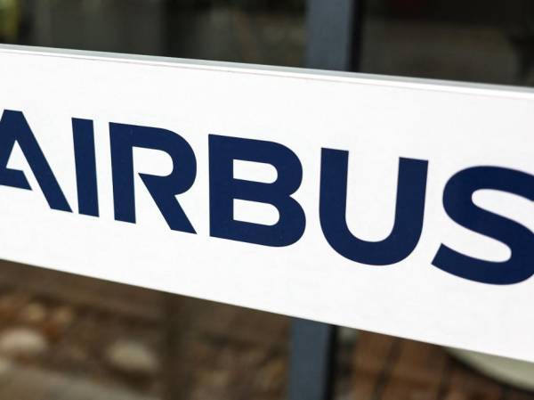 (FILES) A photograph shows an information sign depicting the logo of Airbus at the entrance of a building of the Airbus Defence and Space headquarters in Toulouse, southwestern France on October 21, 2022. European aircraft manufacturer Airbus said on July 26, 2023 its net profit fell in the first half of the year despite an increase in revenue and deliveries. (Photo by Charly TRIBALLEAU / AFP)
