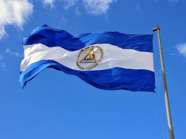 Nicaraguan flag waving in the wind at Plaza de la Revolución / Plaza de la República, Managua