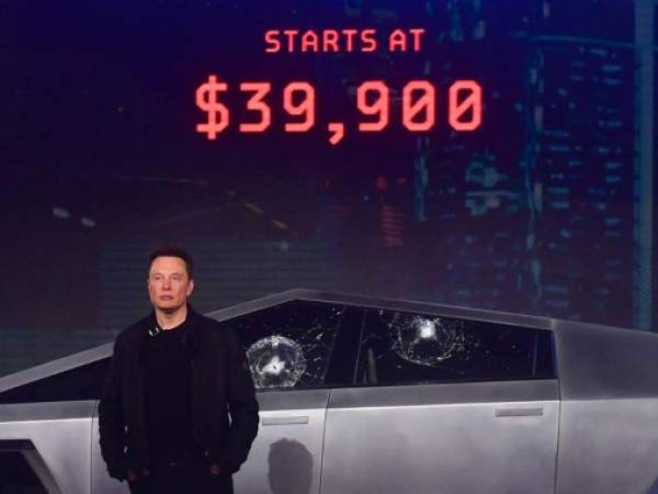 Tesla co-founder and CEO Elon Musk stands in front of the newly unveiled all-electric battery-powered Tesla's Cybertruck at Tesla Design Center in Hawthorne, California on November 21, 2019. (Photo by FREDERIC J. BROWN / AFP)