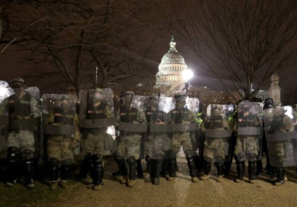 WASHINGTON, DC - JANUARY 06: Members of the National Guard assist police officers line up as they assist police in dispersing protesters who are gathering at the U.S. Capitol Building on January 06, 2021 in Washington, DC. Pro-Trump protesters entered the U.S. Capitol building after mass demonstrations in the nation's capital during a joint session Congress to ratify President-elect Joe Biden's 306-232 Electoral College win over President Donald Trump. Tasos Katopodis/Getty Images/AFP